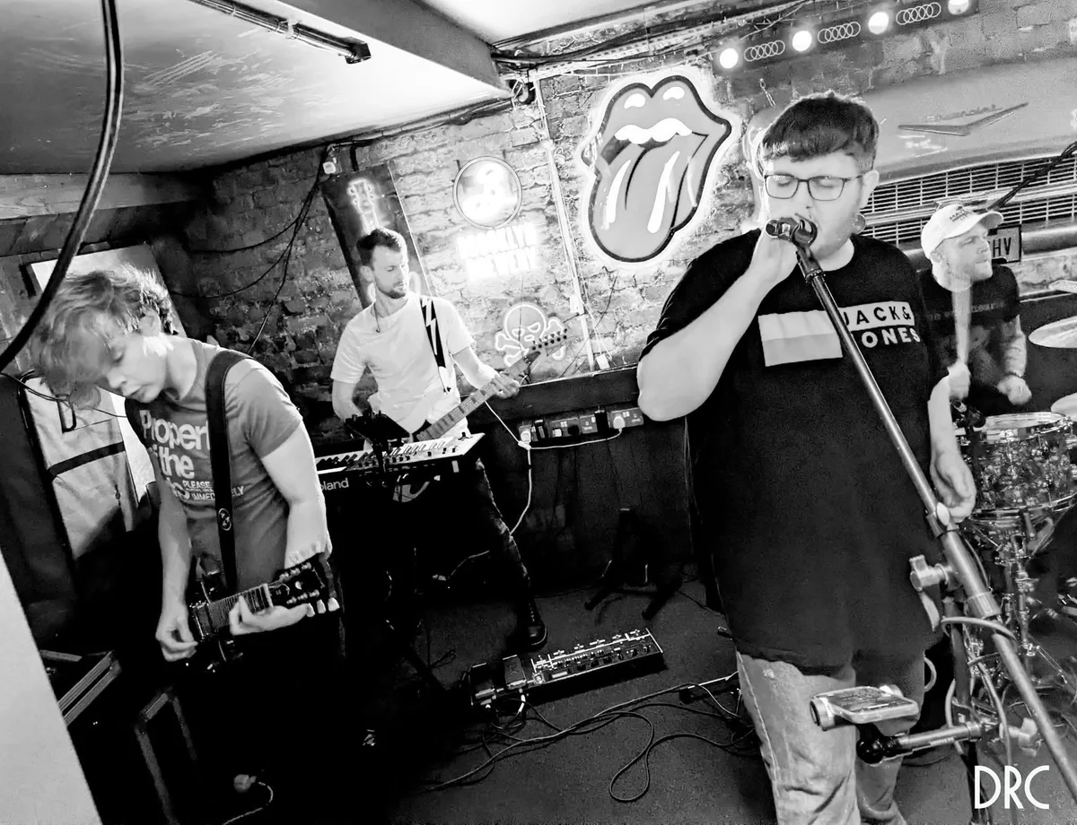 Last Laugh Lane playing live: guitars, vocals, keys and drums. Photograph by DRC.